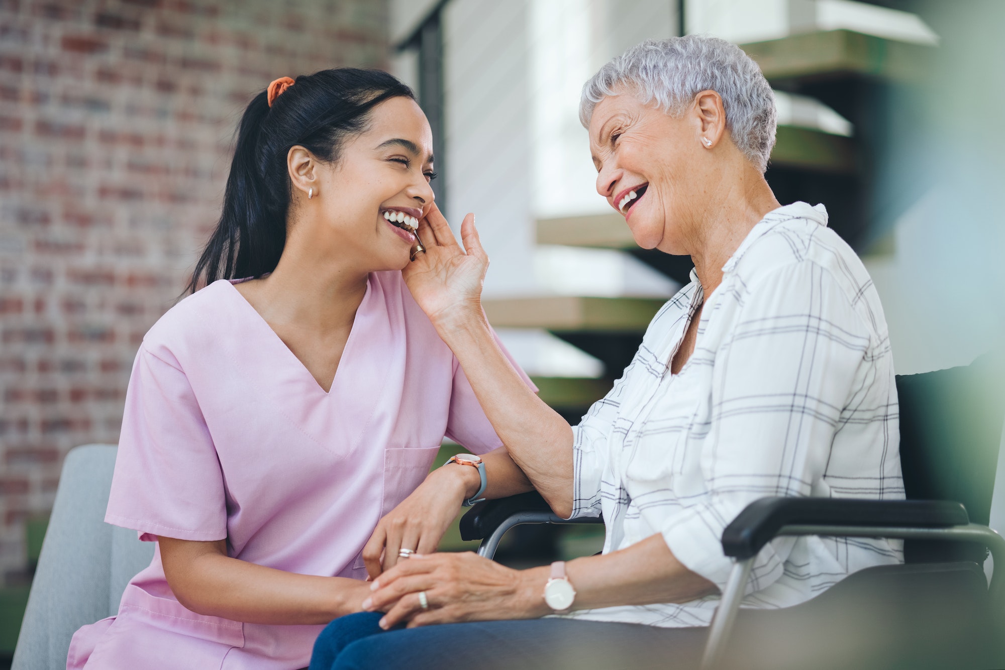 Shot of a young nurse caring for an older woman in a wheelchair